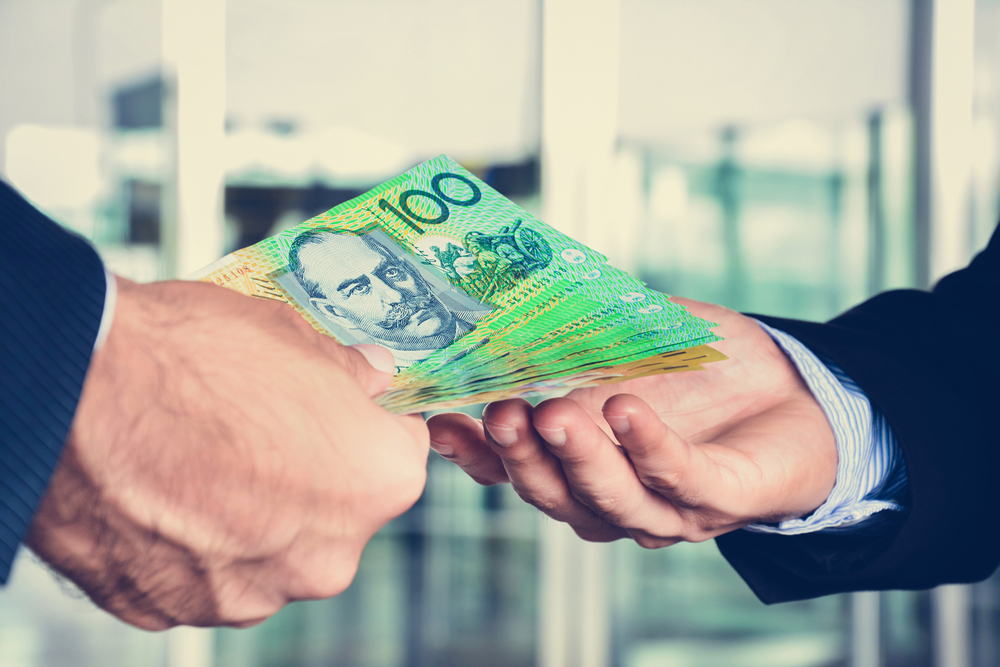 Hands,Of,Businessmen,Passing,Money,,Australia,Dollar,(aud),Banknotes